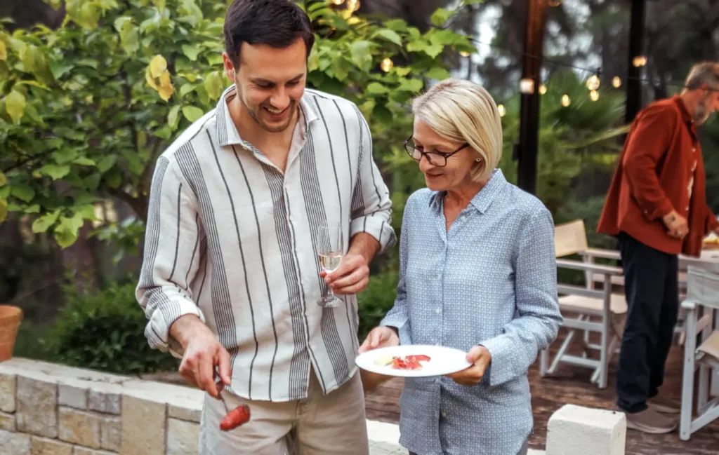 Two people talk during a backyard get together