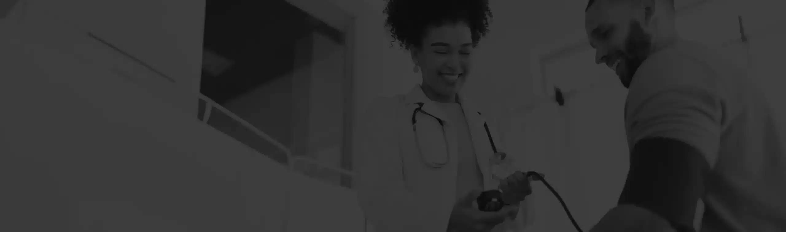 A doctor takes a patient's blood pressure.