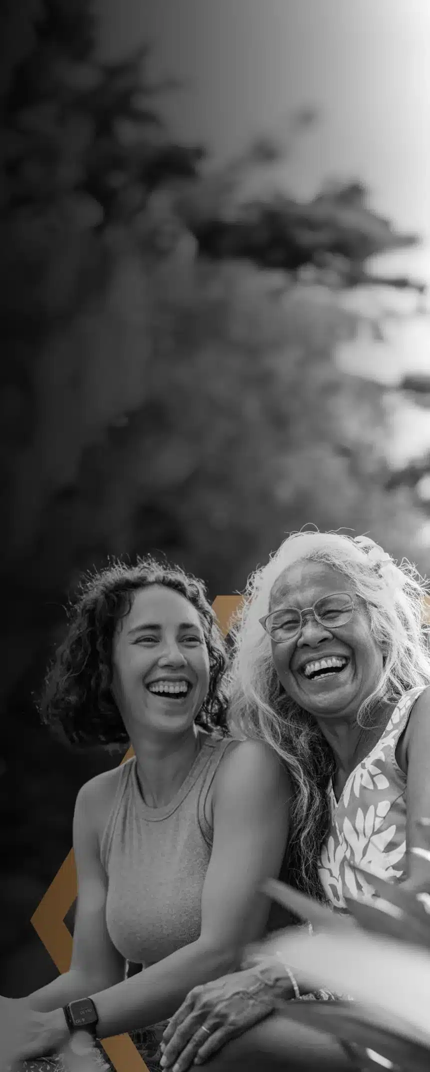 A mother and daughter laugh.